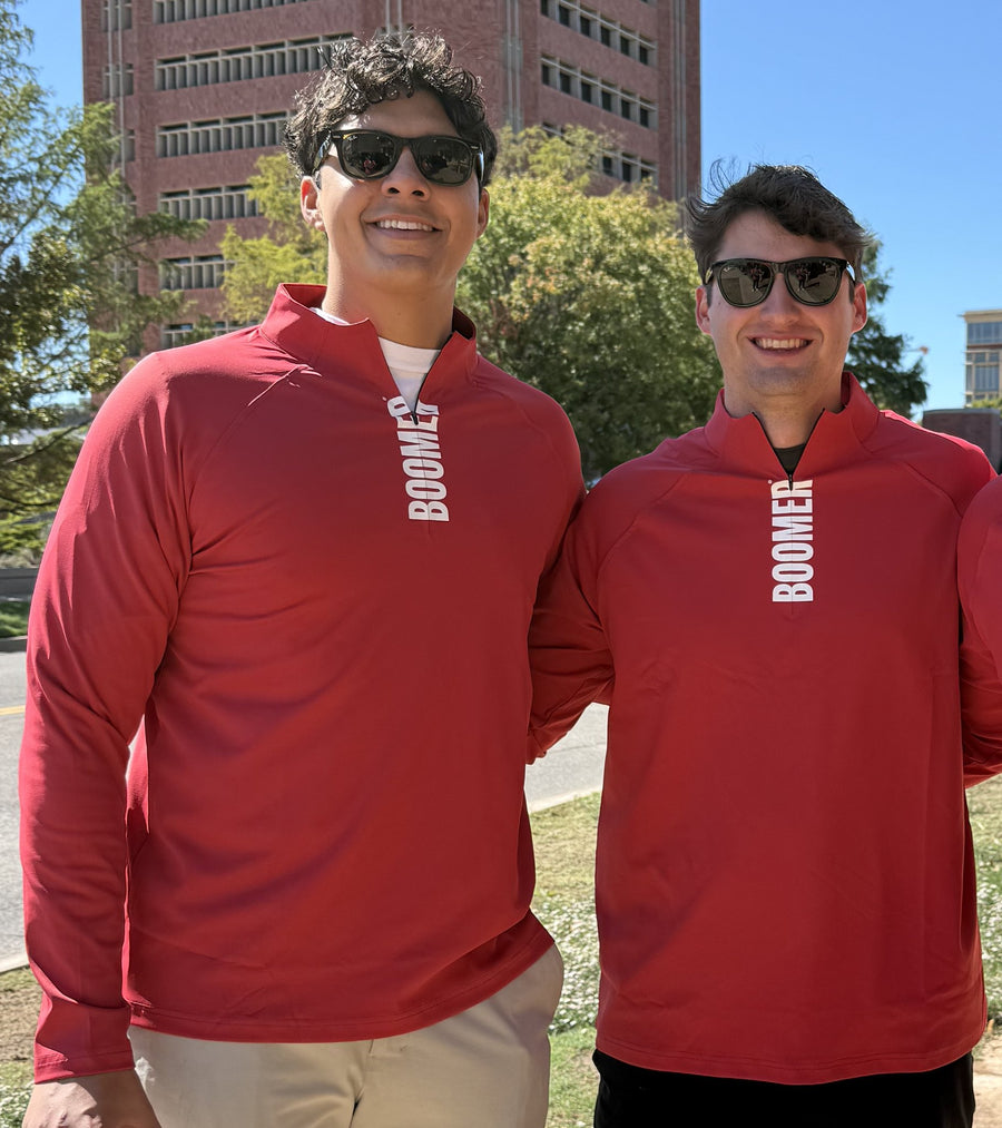 Two fans in GMDY Oklahoma crimson quarter zips on game day