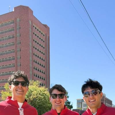 Three fans in GMDY Oklahoma crimson quarter zips on campus
